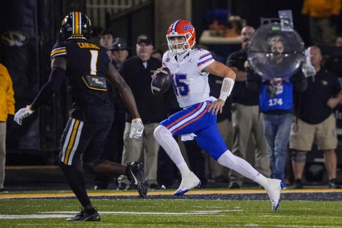 Nov 18, 2023; Columbia, Missouri, USA; Florida Gators quarterback Graham Mertz (15) runs the ball as Missouri Tigers defensive back JC Carlies (1) chases during the first half at Faurot Field at Memorial Stadium. Mandatory Credit: Denny Medley-USA TODAY Sports